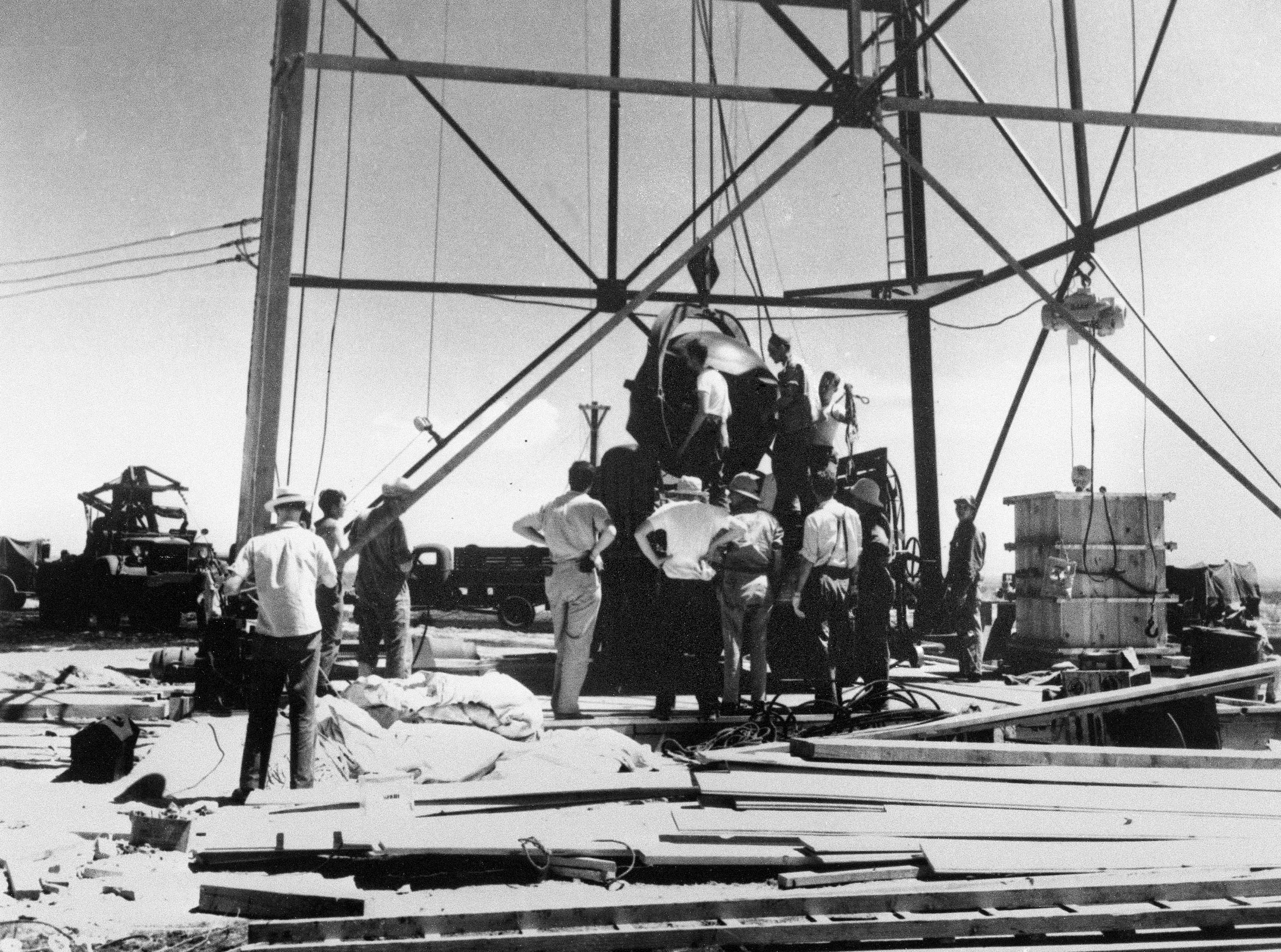 FILE - Scientists and other workers rig the world's first atomic bomb to raise it up onto a 100-foot tower at the Trinity Test Site near Alamogordo, N.M. The New Mexico site where the world’s first atomic bomb was detonated is expecting thousands of visitors Saturday due to the popularity of the movie, "Oppenheimer." Trinity Site, a designated National Historic Landmark, only opens to the public twice a year. (AP Photo/File )