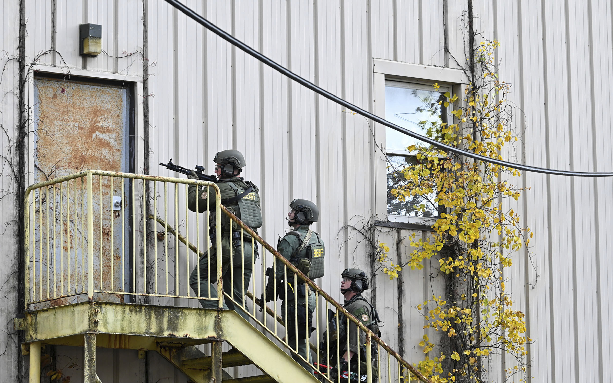 Officers with the Frederick County Sheriiff's Dept. SWAT Team search for suspect Pedro Argote at the former Garden State Tannery plant in Williamsport, Md. on Saturday, Oct. 21, 2023. Washington County Sheriff Brian Albert said authorities are “actively working” to apprehend 49-year-old Pedro Argote for the “targeted attack” of Maryland Circuit Court Judge Andrew Wilkinson. (Ric Dugan/The Frederick News-Post via AP)